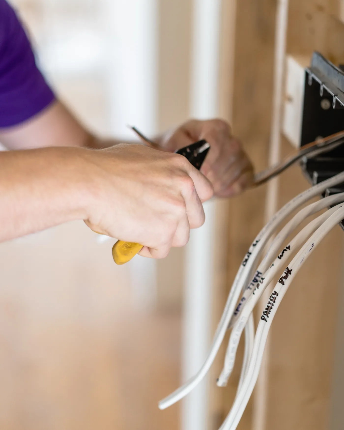 Paul connecting electrical wiring during a residential electrical installation