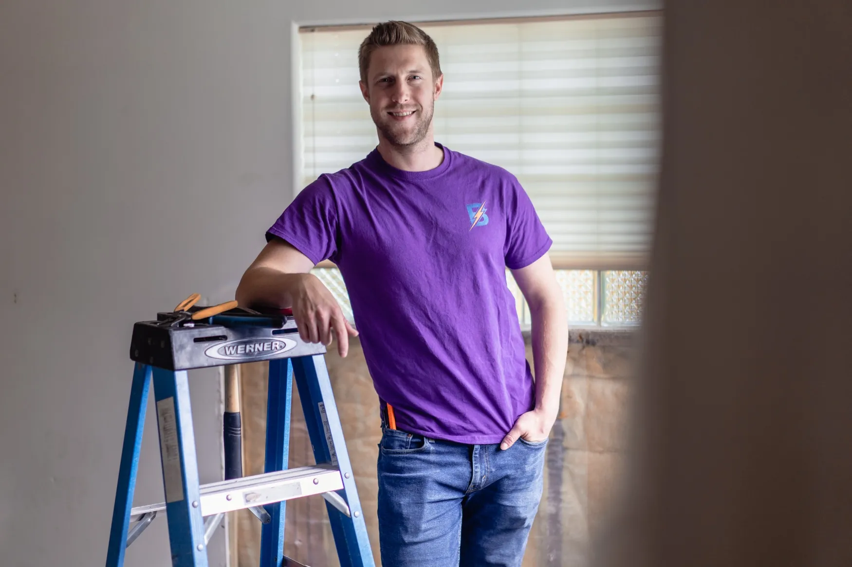 Paul of Brilliant Electric standing beside a ladder during residential renovation electrical work